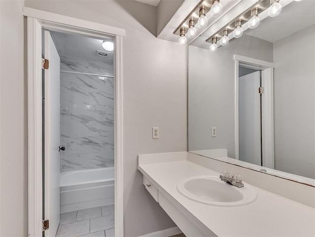 full bath with  shower combination, vanity, and tile patterned floors