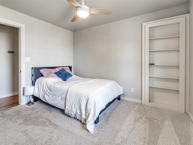 carpeted bedroom featuring ceiling fan and baseboards