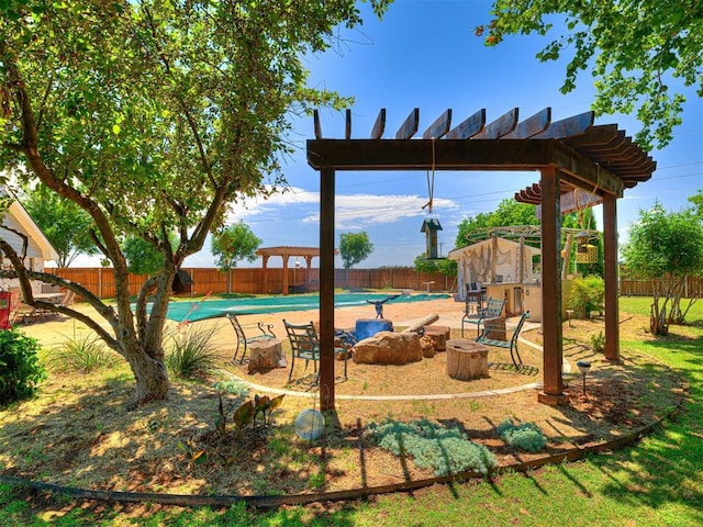 exterior space featuring a fenced in pool, an outdoor fire pit, and a fenced backyard