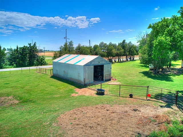 view of pole building featuring a rural view, a yard, and fence