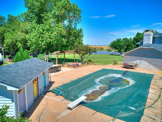 view of swimming pool featuring outdoor dining space, a water view, a patio, and a lawn