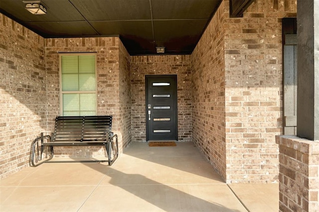 property entrance with brick siding