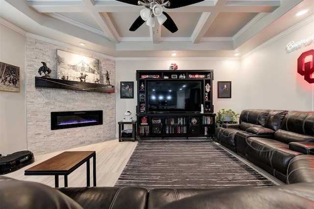 living area featuring coffered ceiling, beamed ceiling, a stone fireplace, and wood finished floors