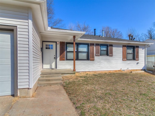 view of front of home featuring an attached garage and a front lawn