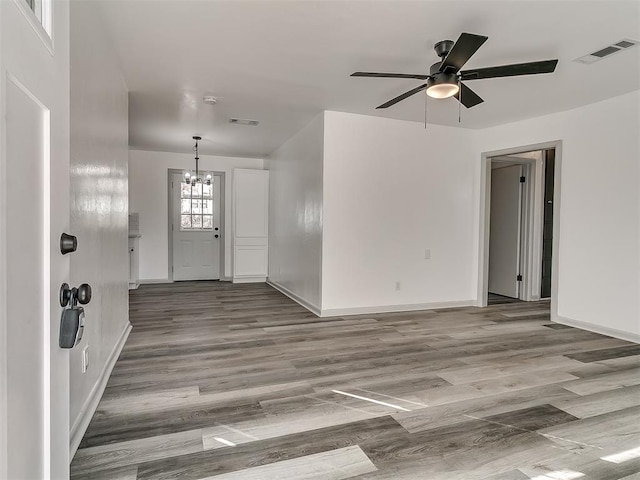 entryway with wood finished floors, visible vents, and baseboards