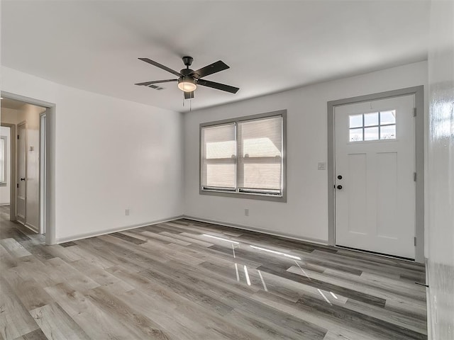 foyer with visible vents, a ceiling fan, light wood-style flooring, and a healthy amount of sunlight