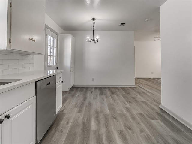 kitchen featuring visible vents, white cabinetry, light countertops, light wood-type flooring, and dishwasher