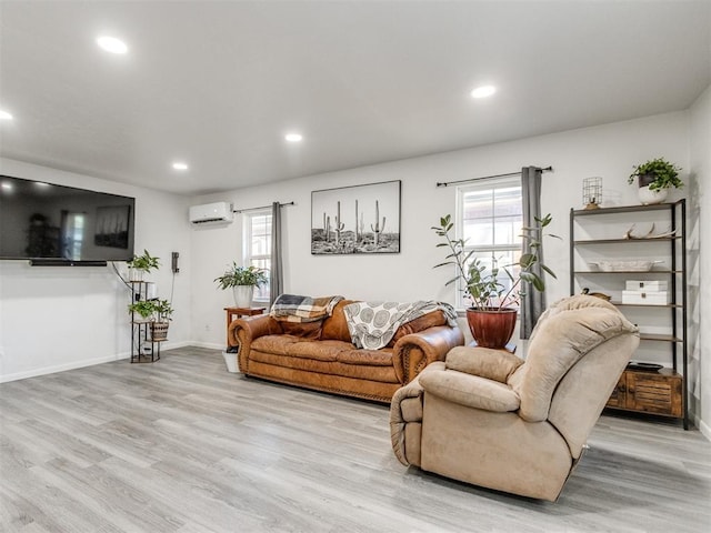 living room with light wood-style floors, recessed lighting, a wall unit AC, and baseboards