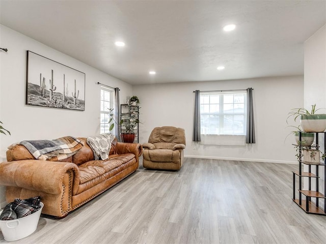 living room featuring a healthy amount of sunlight, light wood finished floors, and recessed lighting