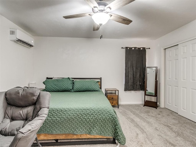 bedroom with baseboards, light colored carpet, ceiling fan, an AC wall unit, and a closet
