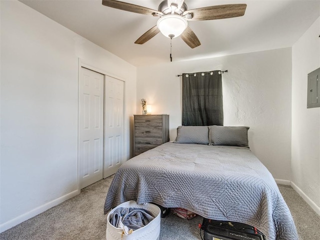 carpeted bedroom with a ceiling fan, electric panel, baseboards, and a closet
