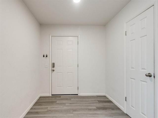interior space with light wood-style flooring and baseboards