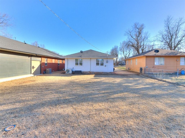 back of house featuring fence and central air condition unit