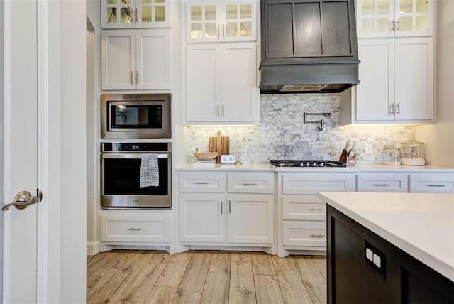 kitchen with white cabinetry, stainless steel appliances, and light countertops