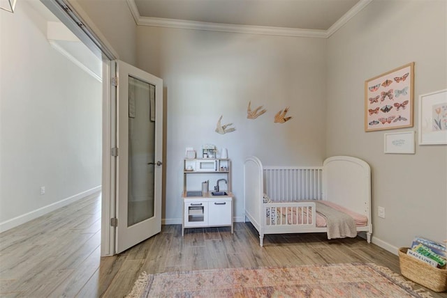 unfurnished bedroom featuring baseboards, ornamental molding, and wood finished floors