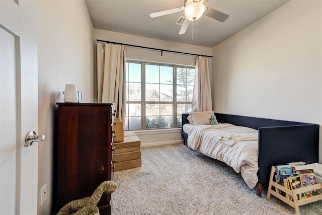 carpeted bedroom with ceiling fan, visible vents, and baseboards