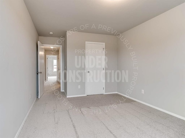 unfurnished bedroom featuring carpet, a closet, and baseboards