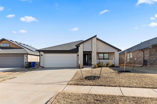 view of front facade with driveway, brick siding, roof with shingles, and an attached garage