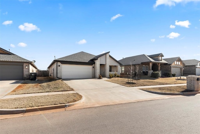 view of front facade featuring concrete driveway, brick siding, fence, and an attached garage