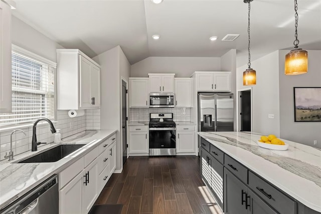 kitchen featuring stainless steel appliances, visible vents, a sink, and white cabinetry