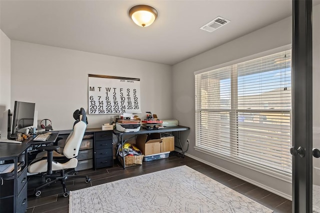 home office with baseboards, visible vents, and wood finish floors