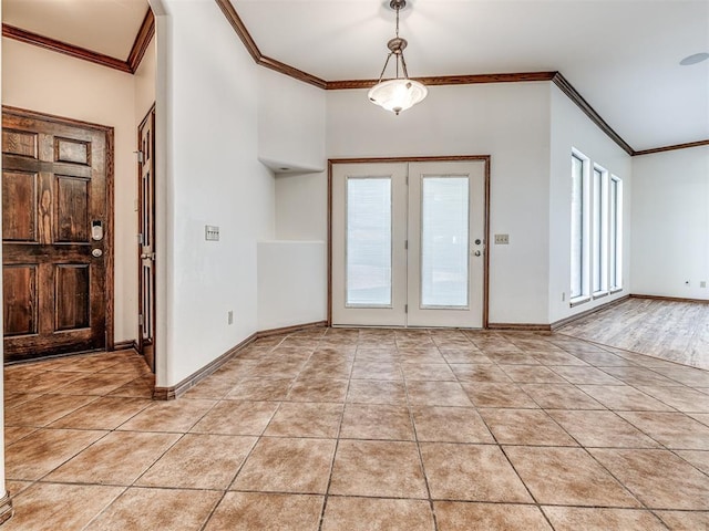 foyer entrance with light tile patterned floors, baseboards, and crown molding