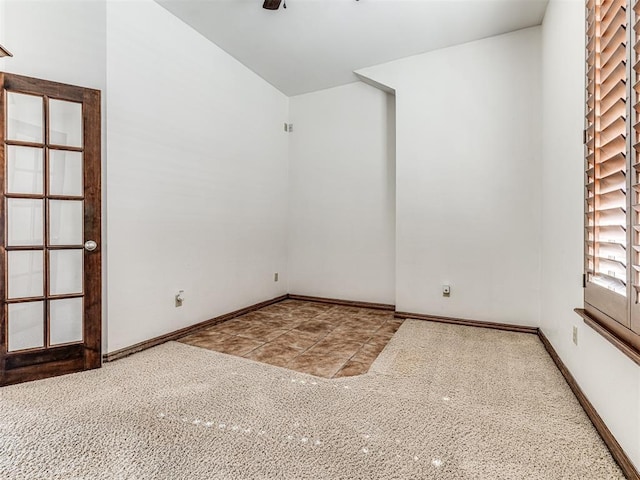 spare room featuring baseboards