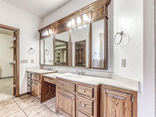 bathroom with double vanity, tile patterned flooring, and a sink