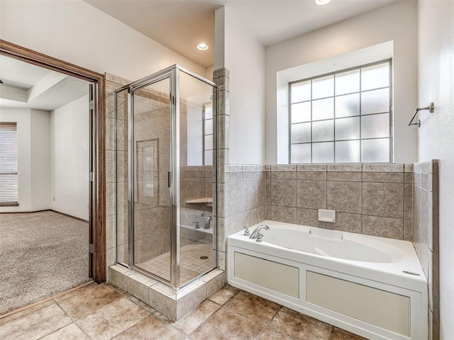 bathroom with a stall shower, recessed lighting, a bath, and tile patterned floors