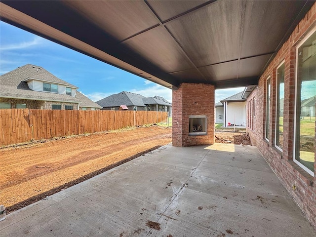 15428 Hatterly Ln, Edmond, OK 73013 - view of patio / terrace with an outdoor brick fireplace
