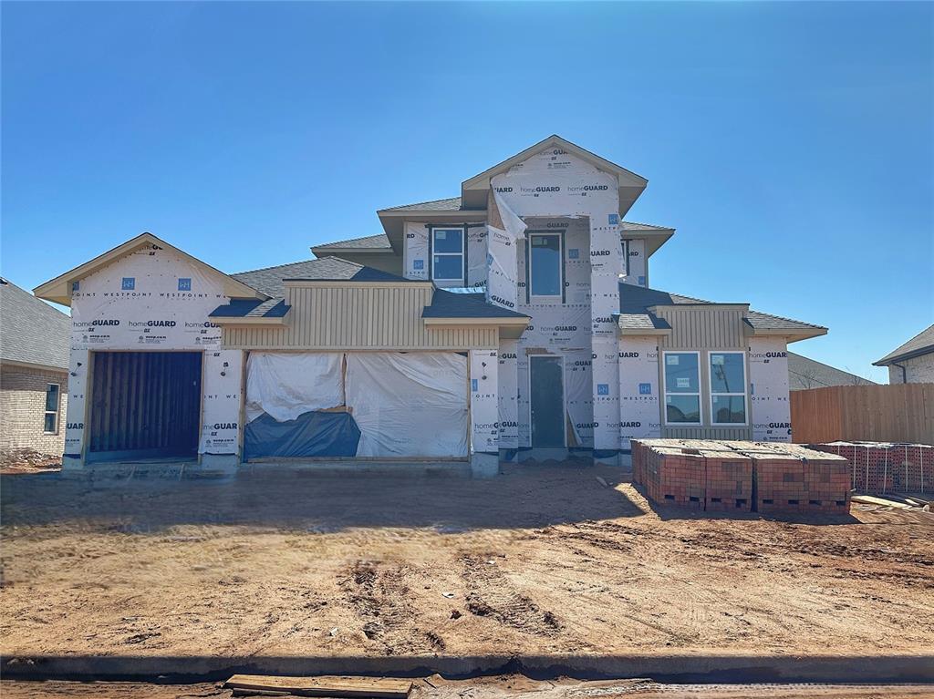 unfinished property with an attached garage and fence