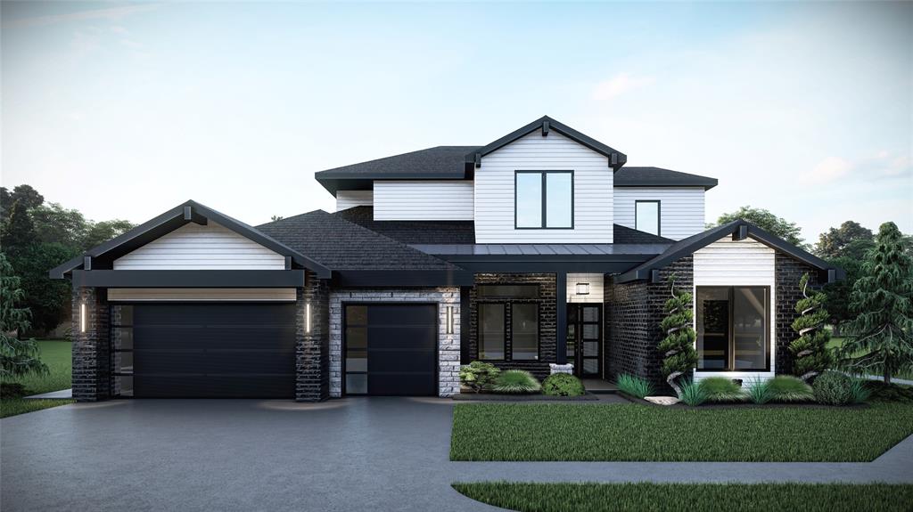 view of front facade with metal roof, an attached garage, concrete driveway, a standing seam roof, and a front yard