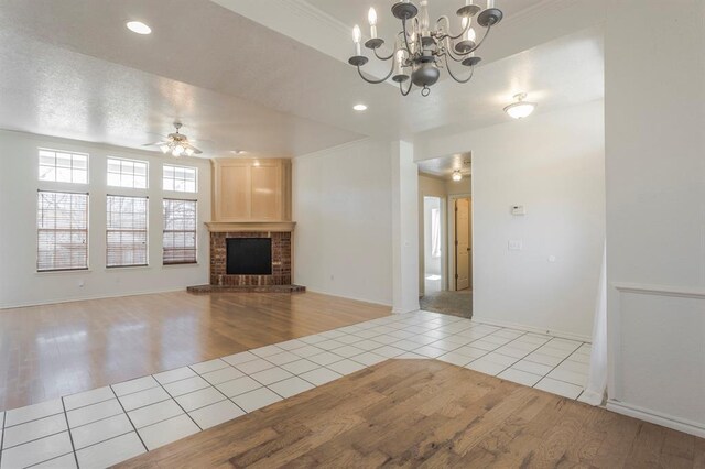 3005 Weymouth Way, Norman, OK 73071 - unfurnished living room featuring tile patterned floors, a fireplace, a chandelier, a ceiling fan, and recessed lighting