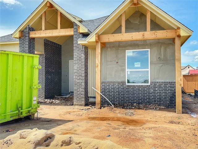 6409 NW 153rd St, Edmond, OK 73013 - view of front of house with brick siding, fence, and a shingled roof