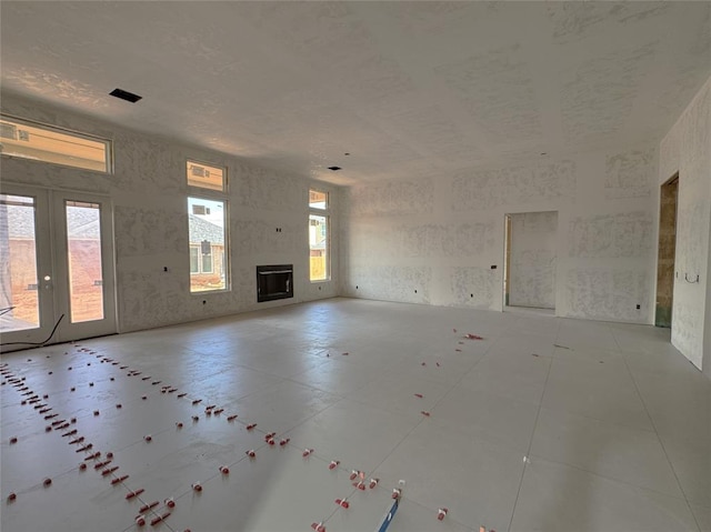 6409 NW 153rd St, Edmond, OK 73013 - unfurnished living room featuring french doors and a fireplace