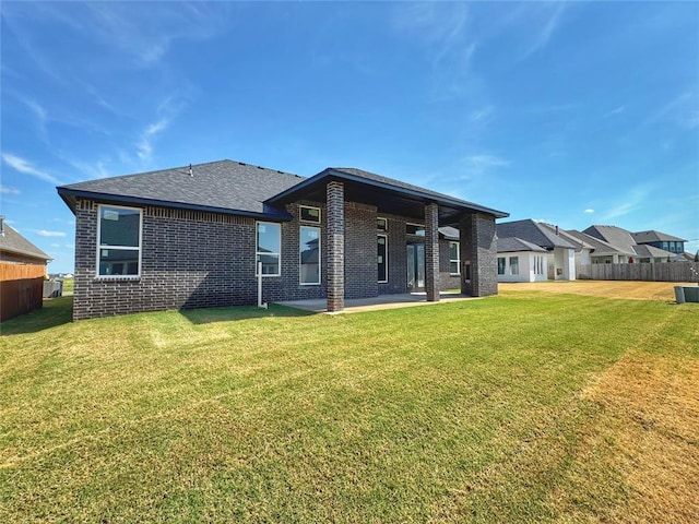 6409 NW 153rd St, Edmond, OK 73013 - back of property featuring brick siding, a patio, and roof with shingles