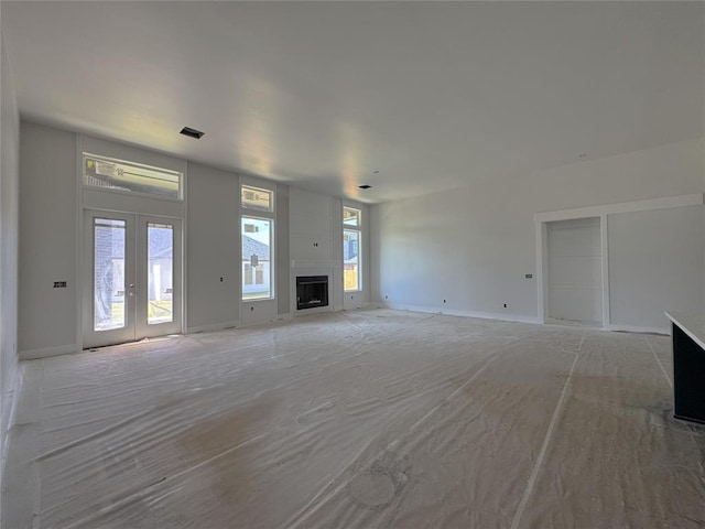 6409 NW 153rd St, Edmond, OK 73013 - unfurnished living room with a large fireplace and french doors