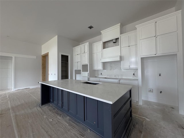 6409 NW 153rd St, Edmond, OK 73013 - kitchen featuring white cabinets, a large island with sink, tasteful backsplash, light stone countertops, and open shelves