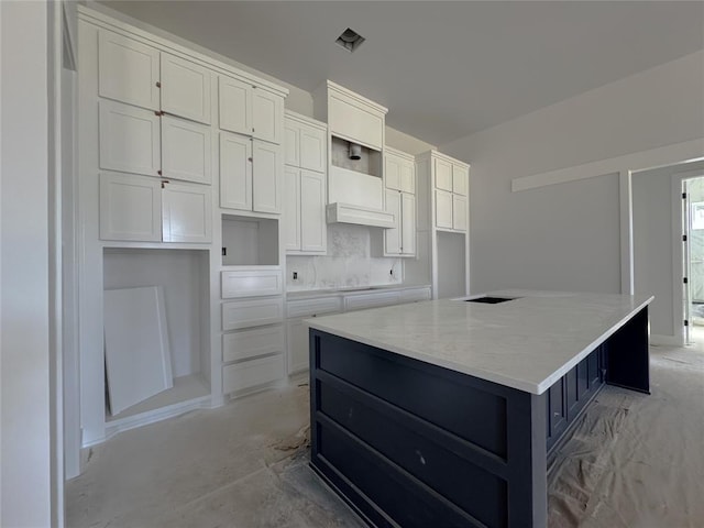 6409 NW 153rd St, Edmond, OK 73013 - kitchen with a spacious island, white cabinets, concrete floors, and stovetop
