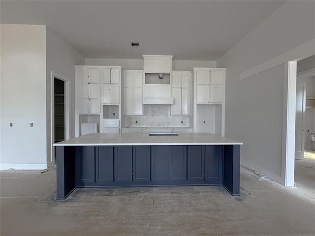 6409 NW 153rd St, Edmond, OK 73013 - kitchen with white cabinetry, a large island, decorative backsplash, and light countertops