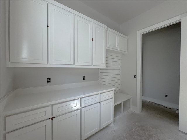 6409 NW 153rd St, Edmond, OK 73013 - kitchen featuring white cabinetry, light countertops, and concrete floors
