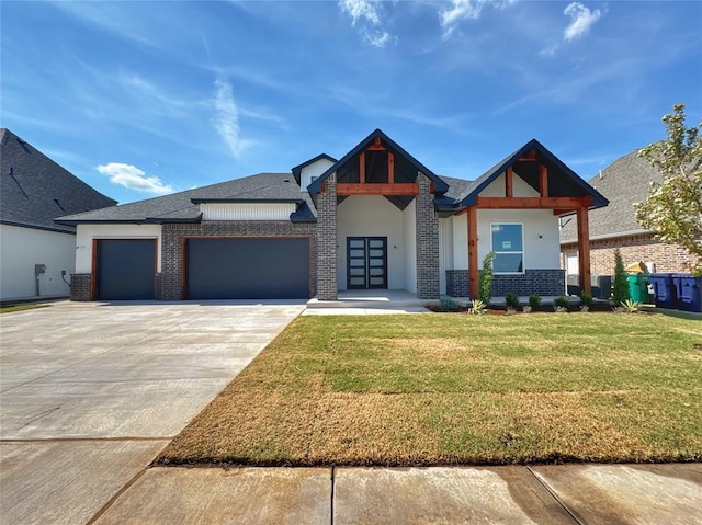 6409 NW 153rd St, Edmond, OK 73013 - view of front of property with brick siding, a garage, a front lawn, and concrete driveway