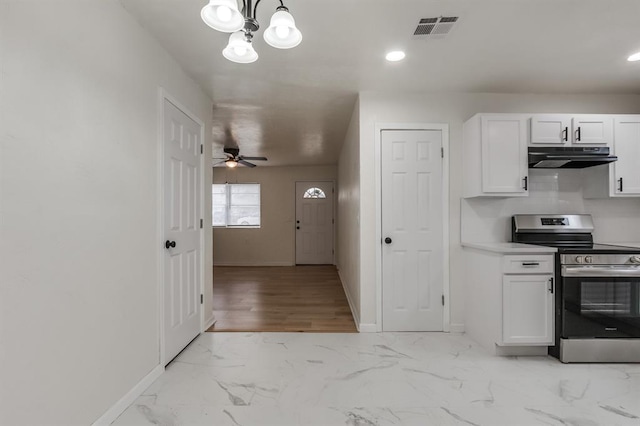 kitchen featuring under cabinet range hood, visible vents, white cabinets, marble finish floor, and stainless steel electric stove