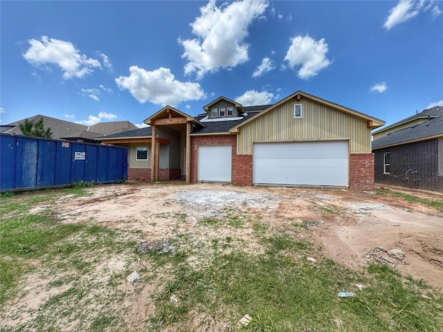 6309 NW 154th Ter, Edmond, OK 73013 - view of front of property featuring brick siding, a garage, and driveway