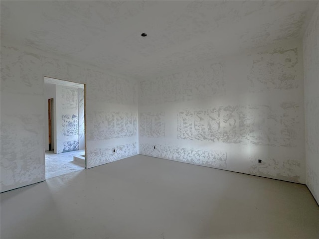 6309 NW 154th Ter, Edmond, OK 73013 - spare room featuring finished concrete floors