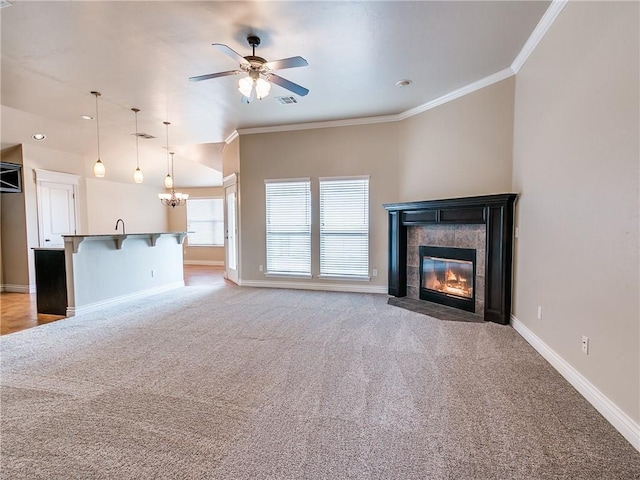 unfurnished living room featuring baseboards, ornamental molding, light colored carpet, and a tile fireplace