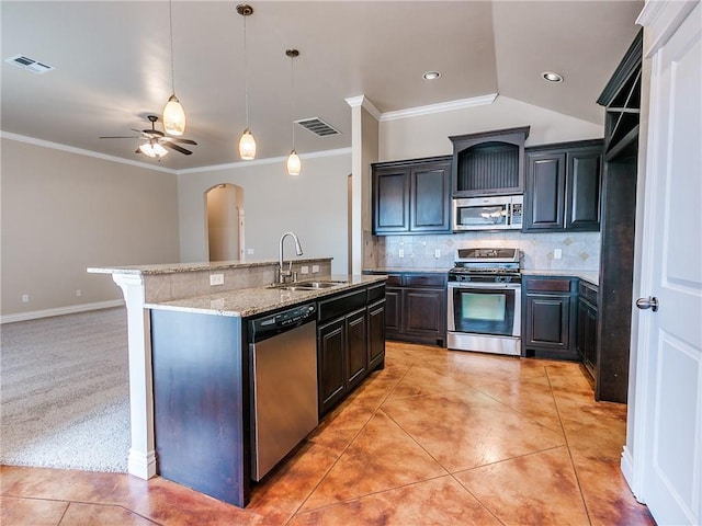 kitchen featuring light tile patterned floors, appliances with stainless steel finishes, a sink, and visible vents