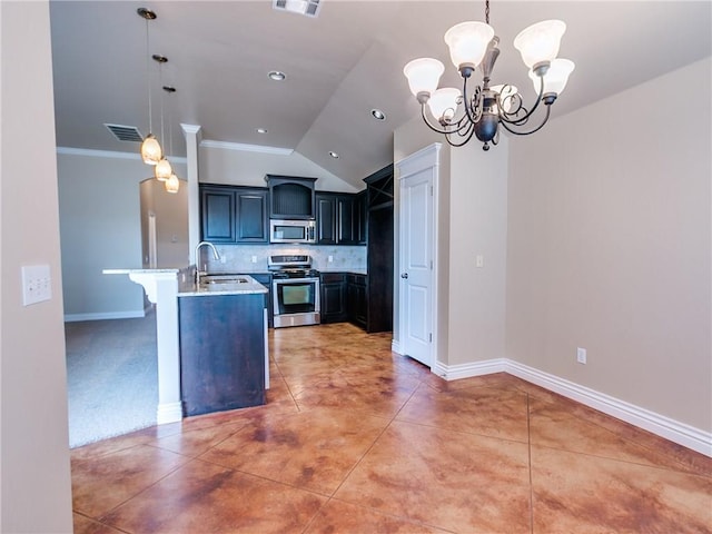 kitchen featuring visible vents, decorative backsplash, appliances with stainless steel finishes, a sink, and a peninsula