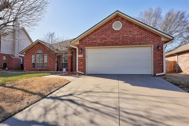 ranch-style house featuring a garage, fence, concrete driveway, and brick siding