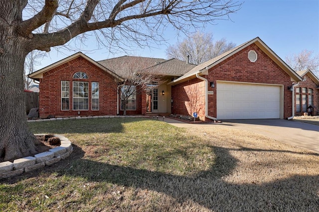 ranch-style home featuring driveway, brick siding, a front lawn, and an attached garage